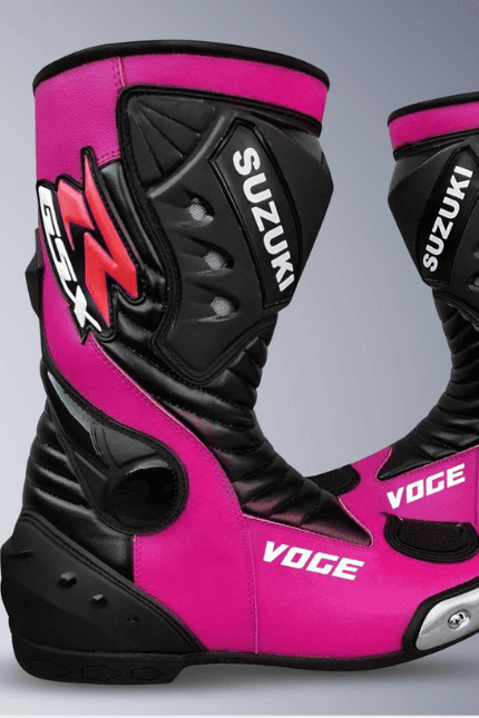 A pair of Suzuki Voge motorcycle boots in vibrant pink and black leather, featuring protective armor plates and branding.
