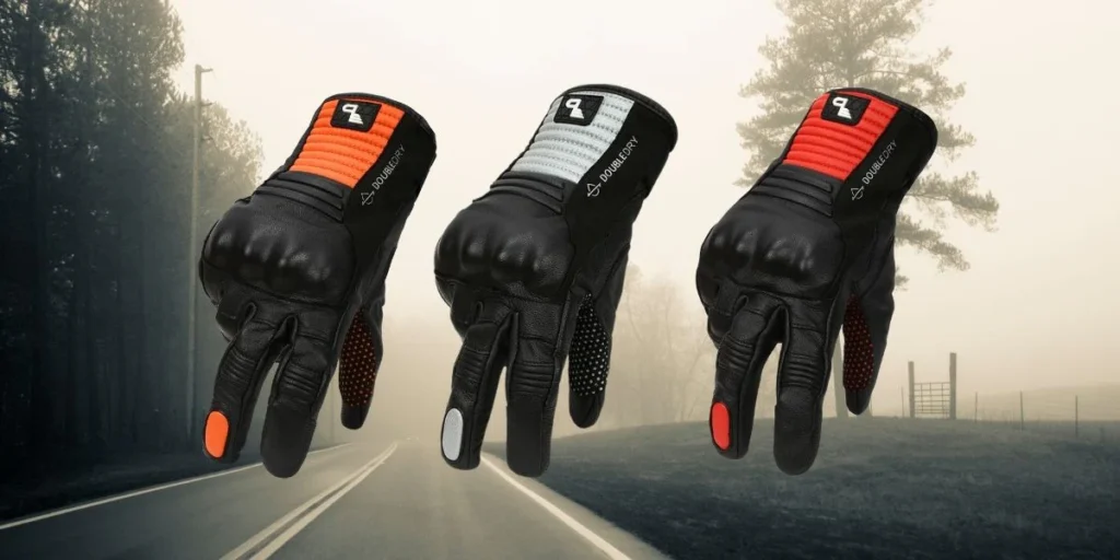 Three pairs of high-performance gloves in various colors hang against a foggy forest backdrop, showcasing durability and style.